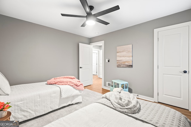 bedroom with ceiling fan and light hardwood / wood-style flooring