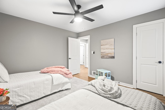 bedroom with ceiling fan and light wood-type flooring