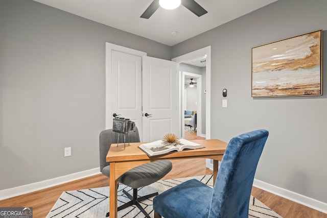 office space featuring light hardwood / wood-style floors and ceiling fan