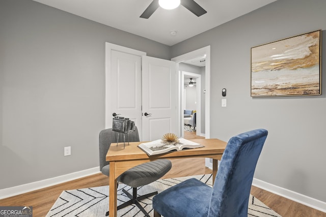 office space with hardwood / wood-style floors and ceiling fan