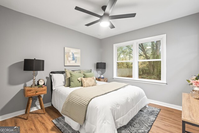 bedroom featuring hardwood / wood-style floors and ceiling fan