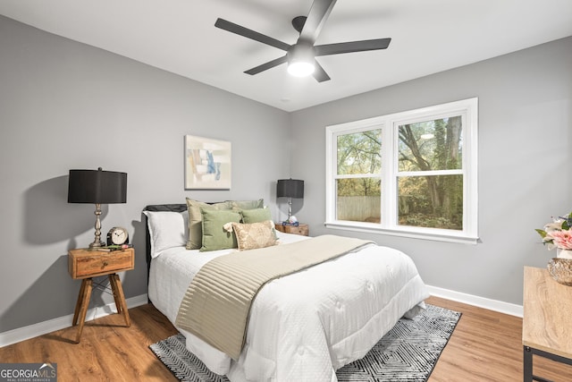 bedroom with hardwood / wood-style floors and ceiling fan