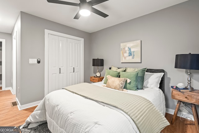 bedroom featuring hardwood / wood-style floors, a closet, and ceiling fan