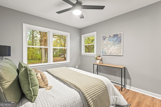 bedroom with ceiling fan and light hardwood / wood-style floors