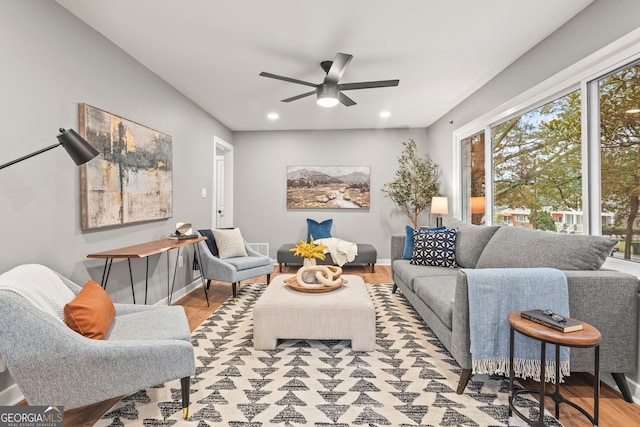 living room featuring ceiling fan and light hardwood / wood-style floors