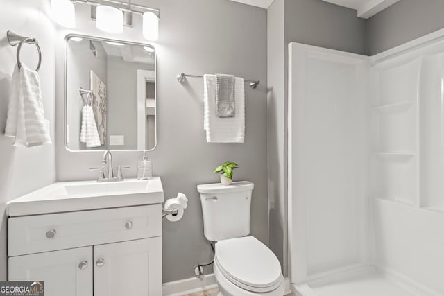 bathroom featuring walk in shower, vanity, and toilet