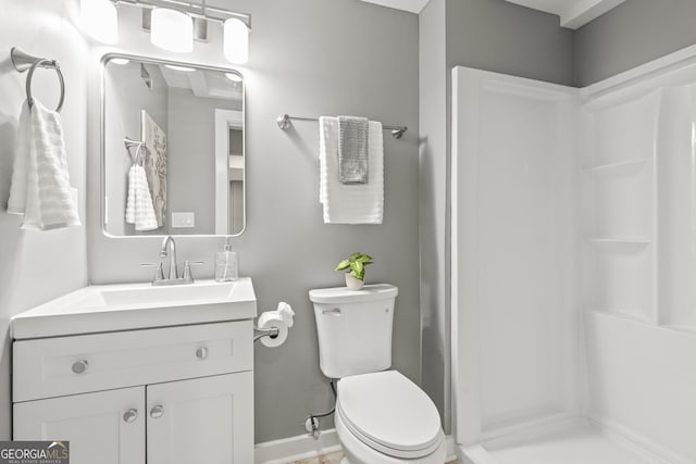 bathroom featuring vanity, toilet, and walk in shower