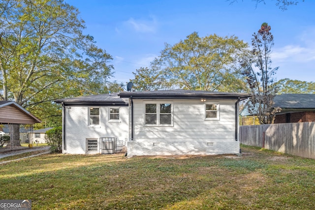 rear view of property with a lawn