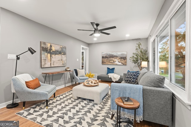 living room featuring hardwood / wood-style flooring and ceiling fan