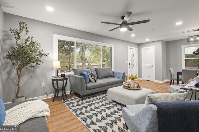 living room featuring hardwood / wood-style floors and ceiling fan