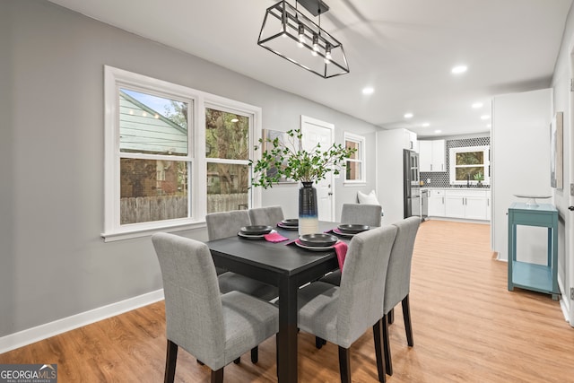 dining space with light hardwood / wood-style flooring