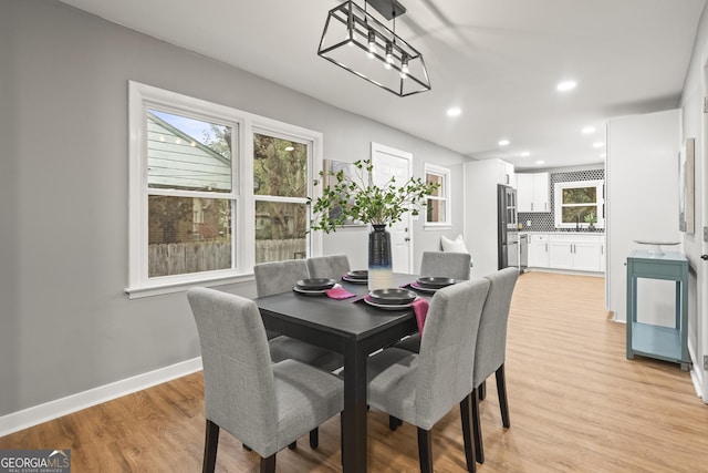 dining room with a chandelier and light hardwood / wood-style flooring