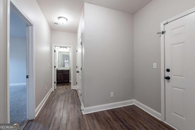 corridor featuring dark wood-type flooring