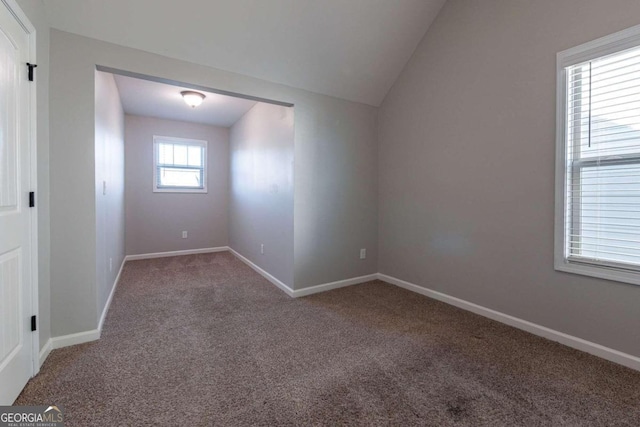 unfurnished room with carpet and lofted ceiling