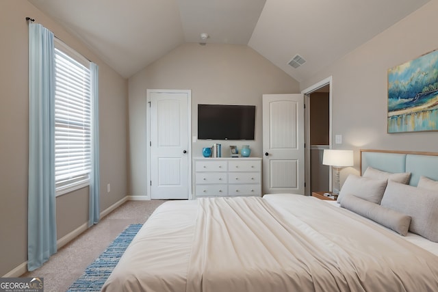 bedroom featuring light carpet, multiple windows, and lofted ceiling