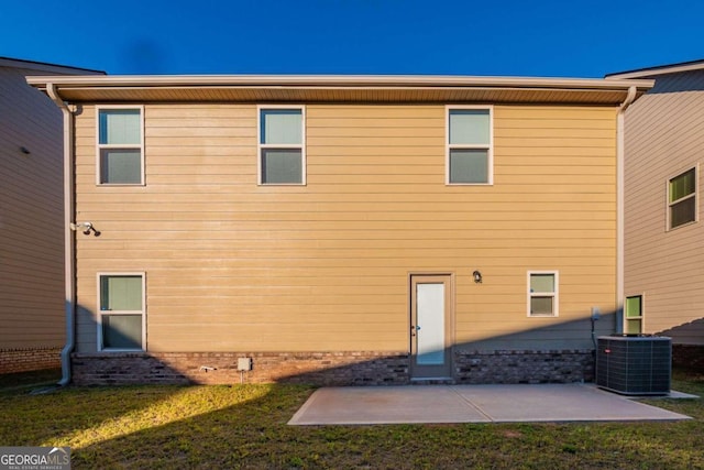 back of house featuring a yard, a patio area, and central AC unit