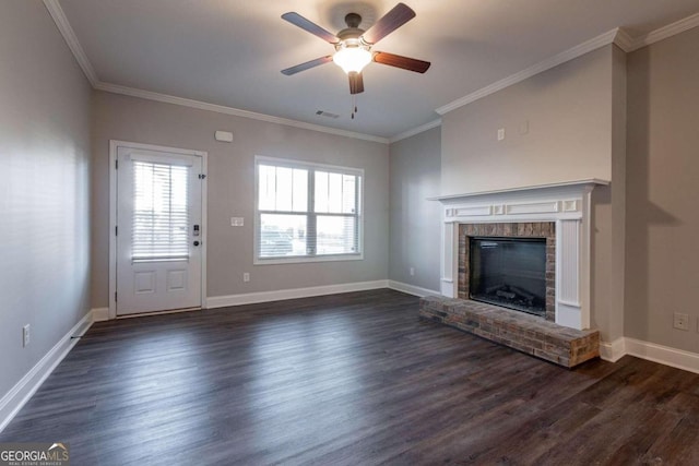 unfurnished living room with crown molding, a brick fireplace, dark hardwood / wood-style floors, and ceiling fan