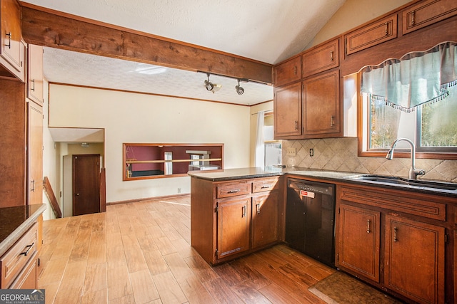 kitchen featuring kitchen peninsula, tasteful backsplash, sink, black dishwasher, and light hardwood / wood-style floors