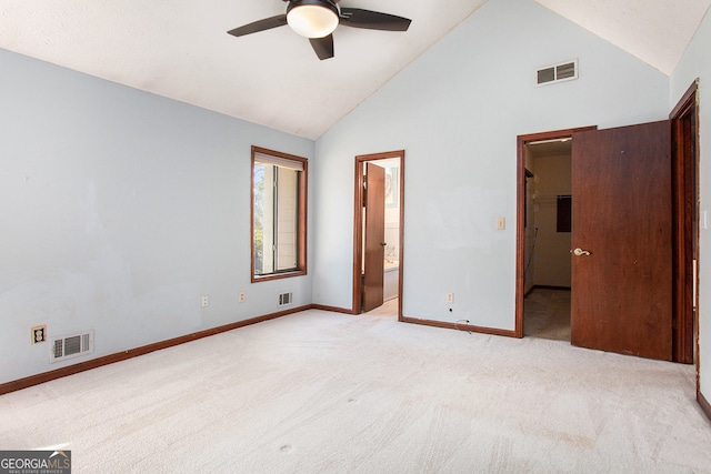 unfurnished bedroom with connected bathroom, light carpet, ceiling fan, and high vaulted ceiling