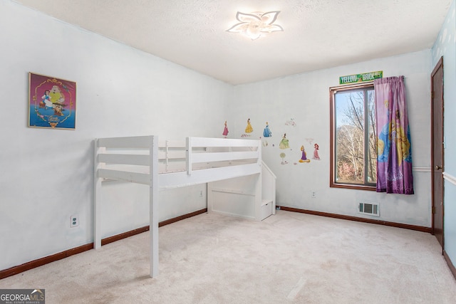 carpeted bedroom featuring a textured ceiling