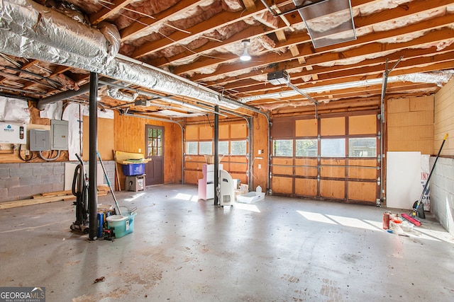 garage featuring a garage door opener and electric panel