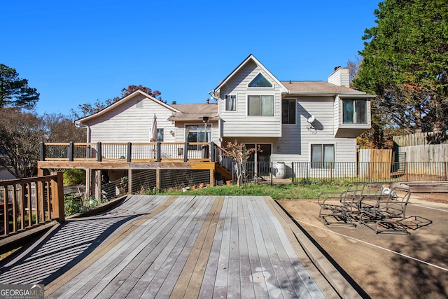 back of house featuring a wooden deck