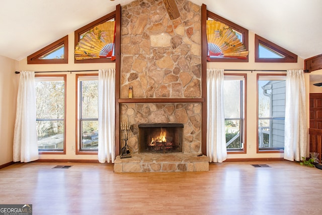 unfurnished living room with wood-type flooring, a fireplace, and high vaulted ceiling