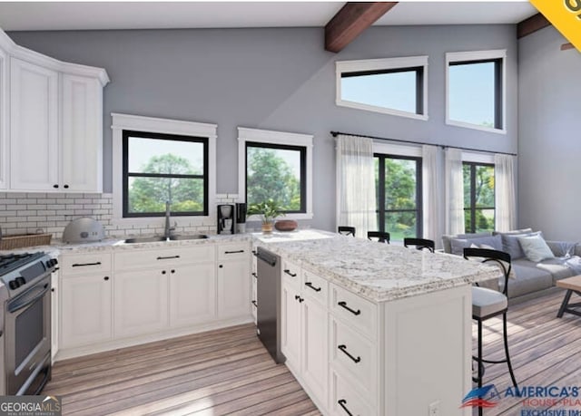 kitchen with white cabinetry, sink, light stone countertops, light wood-type flooring, and appliances with stainless steel finishes