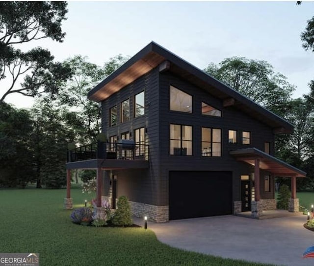 view of side of property with a yard, stone siding, driveway, and a garage