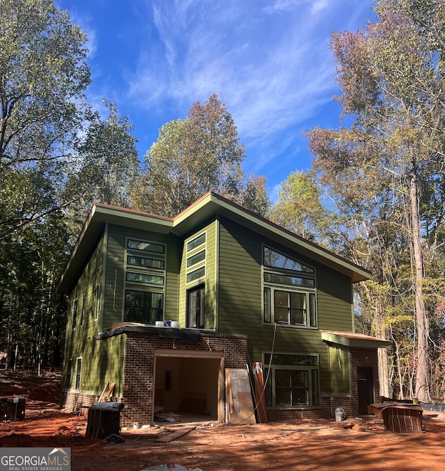 back of property featuring a garage