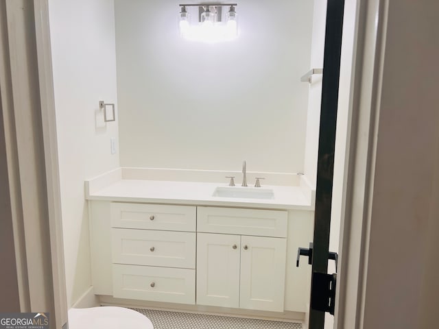 bathroom featuring vanity and toilet