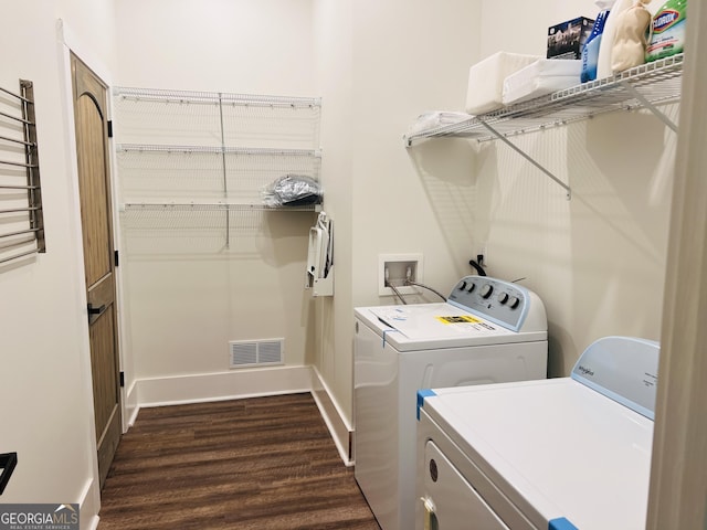 laundry area featuring dark wood-style floors, visible vents, baseboards, laundry area, and washer and dryer