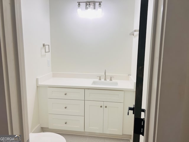 bathroom featuring toilet and vanity