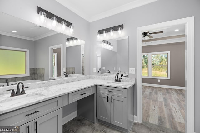 bathroom featuring ceiling fan, crown molding, and vanity