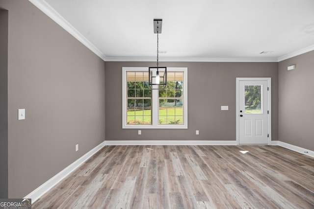 unfurnished dining area with crown molding and light hardwood / wood-style floors