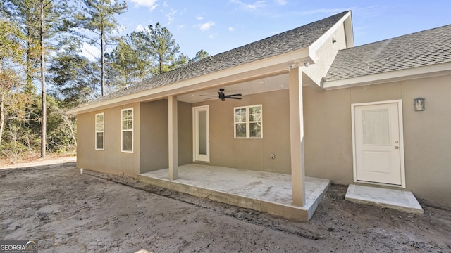 rear view of house with ceiling fan and a patio