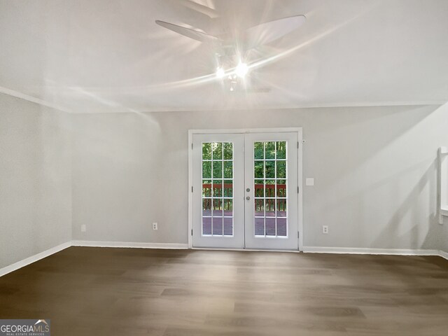 spare room with hardwood / wood-style floors and french doors