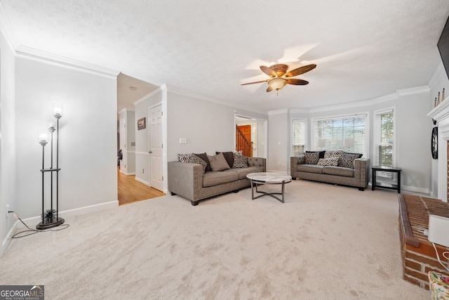 carpeted living room featuring a textured ceiling, ceiling fan, and ornamental molding