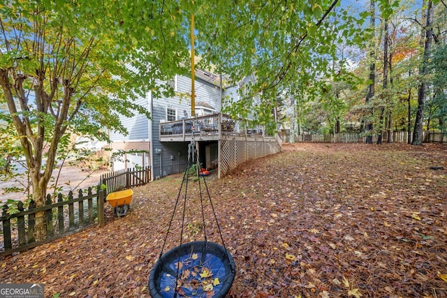 view of yard featuring a garage and a deck