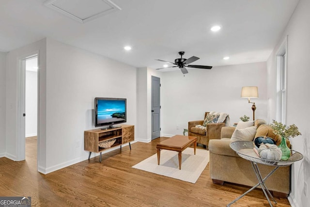 living room featuring hardwood / wood-style flooring and ceiling fan