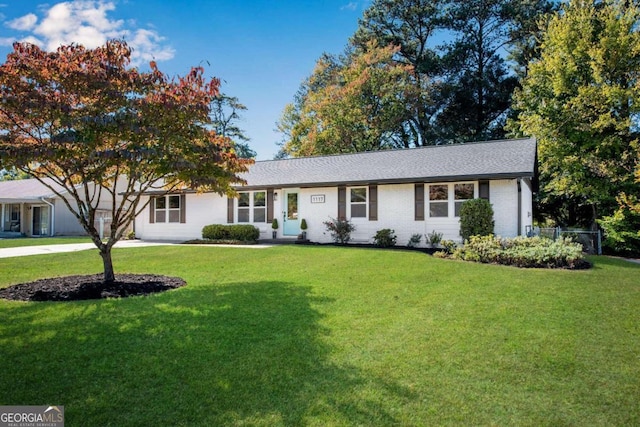 ranch-style house with a front lawn