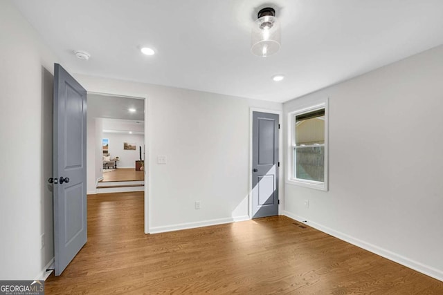 unfurnished bedroom with hardwood / wood-style floors