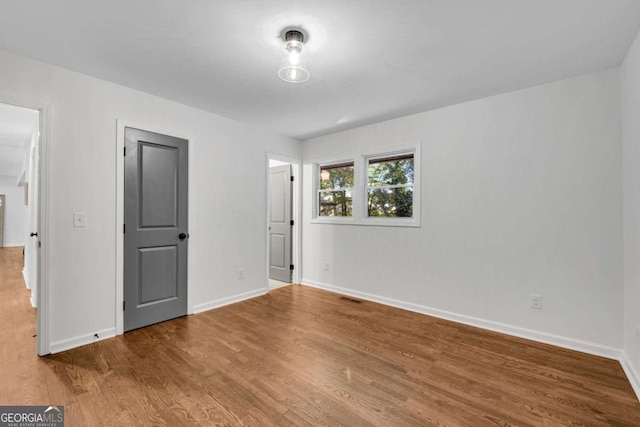 unfurnished bedroom with wood-type flooring