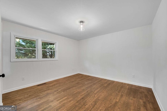 empty room featuring dark hardwood / wood-style flooring