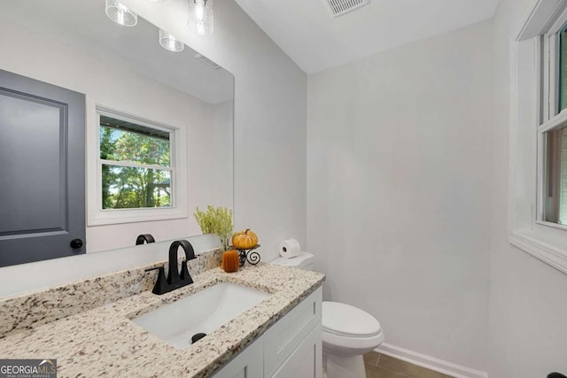 bathroom featuring vanity, toilet, and tile patterned flooring