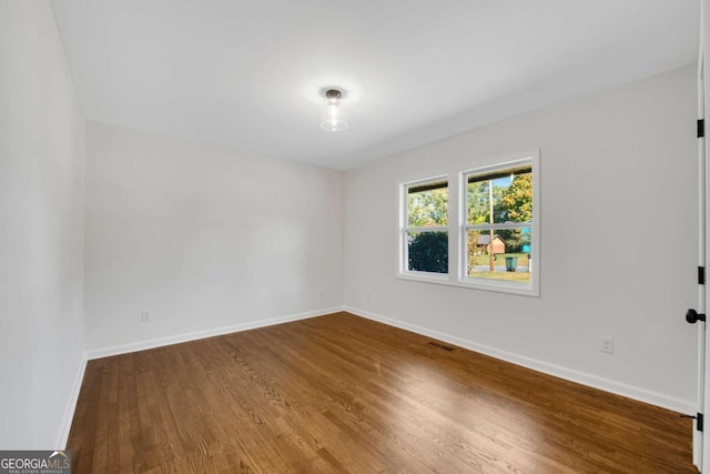 unfurnished room featuring wood-type flooring