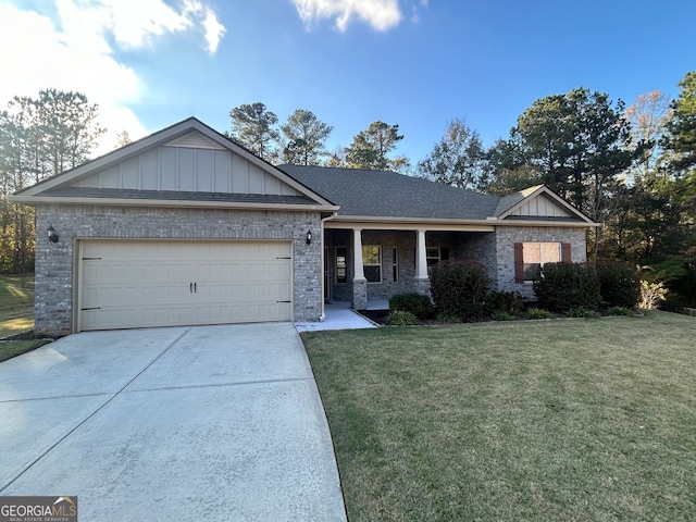 view of front of property featuring a garage and a front lawn