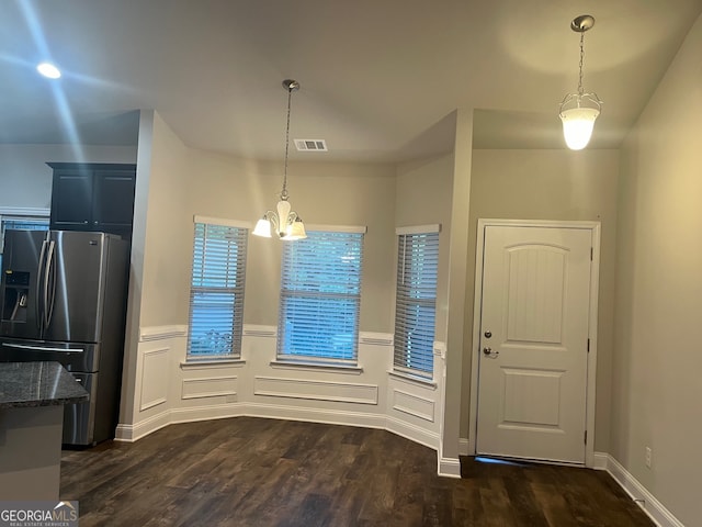 interior space featuring dark hardwood / wood-style floors and a chandelier