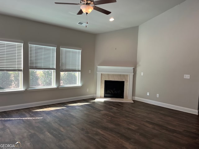 unfurnished living room featuring dark hardwood / wood-style flooring, ceiling fan, and plenty of natural light