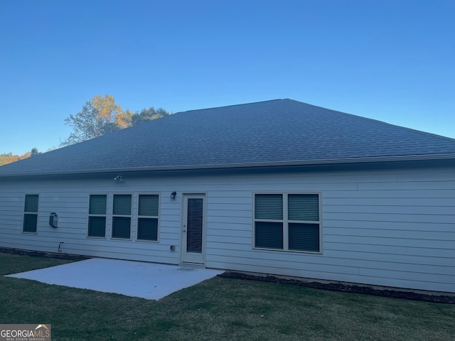 back of property with a patio and a lawn